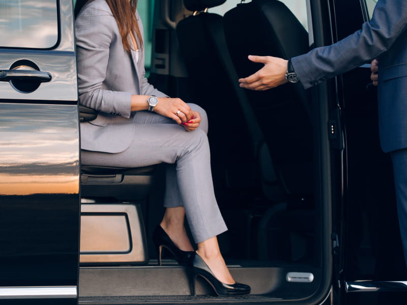corporate woman coming out of minibus during corporate charter service coxsackie ny